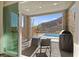 Covered patio with BBQ and seating area overlooks pool with backyard mountain views at 41 Strada Moscato, Henderson, NV 89011