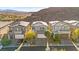 Street view of three modern homes with desert landscaping, large garages, and mountain views at 41 Strada Moscato, Henderson, NV 89011