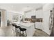 Bright, open kitchen boasts an island with seating and white cabinets at 41 Strada Moscato, Henderson, NV 89011