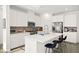 A modern kitchen featuring stainless appliances, white cabinets, and a large center island with barstool seating at 41 Strada Moscato, Henderson, NV 89011