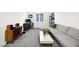 Bright living room features neutral tones, large sectional sofa, and dedicated desk space at 41 Strada Moscato, Henderson, NV 89011