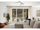 Bright living room featuring sliding glass doors offering backyard views with private pool and covered patio at 41 Strada Moscato, Henderson, NV 89011