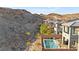 View of a modern home with a pool and mountains in the background at 41 Strada Moscato, Henderson, NV 89011