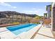 Sparkling pool in backyard featuring clear blue water and stylish concrete decking with a basketball hoop at 41 Strada Moscato, Henderson, NV 89011
