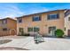Backyard view of a two-story home featuring a patio with outdoor seating and a well-manicured lawn at 4216 Thunder Twice St, Las Vegas, NV 89129
