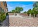 Lush backyard featuring desert landscaping, a stone walkway, a concrete patio, and mature trees for privacy at 4216 Thunder Twice St, Las Vegas, NV 89129