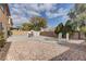Large backyard with mature trees, desert landscaping, and a patio with seating area and water feature at 4216 Thunder Twice St, Las Vegas, NV 89129