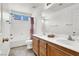Bathroom featuring a double vanity, and a combined tub and shower, and a separate toilet at 4216 Thunder Twice St, Las Vegas, NV 89129