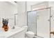 Well-lit bathroom featuring a sleek shower with glass doors, a toilet, and modern fixtures at 4216 Thunder Twice St, Las Vegas, NV 89129