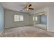 Neutral bedroom with mirrored closet doors, a ceiling fan, and natural light at 4216 Thunder Twice St, Las Vegas, NV 89129