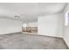 Large bonus room featuring neutral carpeting, ceiling fan, and a staircase with wood banister at 4216 Thunder Twice St, Las Vegas, NV 89129