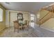 Formal dining room with staircase and views to the living room beyond, neutral carpeting, and patterned wall at 4216 Thunder Twice St, Las Vegas, NV 89129