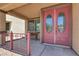 Close-up of elegant double front door with oval glass inserts and a covered porch with cozy seating at 4216 Thunder Twice St, Las Vegas, NV 89129