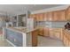 Open kitchen with island, granite countertops, light wood cabinetry, and a tile backsplash at 4216 Thunder Twice St, Las Vegas, NV 89129