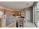 Well-lit kitchen with breakfast bar, tile flooring, and stainless steel appliances; access to backyard patio at 4216 Thunder Twice St, Las Vegas, NV 89129