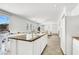Open-concept kitchen featuring white cabinets, granite countertops, and an island with a breakfast bar at 4216 Thunder Twice St, Las Vegas, NV 89129