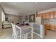 Open-concept kitchen features a center island, tile flooring and a breakfast nook area at 4216 Thunder Twice St, Las Vegas, NV 89129