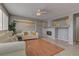 Cozy living room with fireplace, neutral paint, ceiling fan and lots of natural light at 4216 Thunder Twice St, Las Vegas, NV 89129