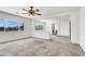 Bright living room with neutral carpet and two windows offers flexible living space at 4216 Thunder Twice St, Las Vegas, NV 89129