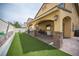 A spacious backyard featuring a covered patio and an artificial grass area at 4440 Pacific Crest Ave, Las Vegas, NV 89115