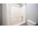 Bathroom featuring shower and tub combo with a shower head and white tiling at 4440 Pacific Crest Ave, Las Vegas, NV 89115