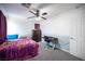 This bedroom has a ceiling fan, carpet, and a desk at 4440 Pacific Crest Ave, Las Vegas, NV 89115