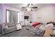 Bedroom with carpet, fan, queen sized bed and grey sofa. A wall has colorful geometric patterns at 4440 Pacific Crest Ave, Las Vegas, NV 89115