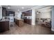 Spacious kitchen with center island, dark cabinets, stainless steel appliances, and wood-look tile flooring at 4440 Pacific Crest Ave, Las Vegas, NV 89115