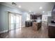 Open kitchen featuring dark cabinetry, stone island, and stainless appliances at 4440 Pacific Crest Ave, Las Vegas, NV 89115