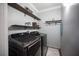 Convenient laundry room with floating shelves and modern appliances, optimizing functionality and style at 4440 Pacific Crest Ave, Las Vegas, NV 89115