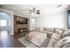 Comfortable living room with a large sectional sofa and mounted TV above stone accent wall at 4440 Pacific Crest Ave, Las Vegas, NV 89115