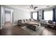 Cozy living room with plush sectional, natural light, and wood-look tile flooring at 4440 Pacific Crest Ave, Las Vegas, NV 89115