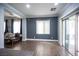 Bright living room with wood-look tile flooring and sliding glass door to the backyard at 4440 Pacific Crest Ave, Las Vegas, NV 89115