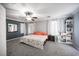 Spacious main bedroom featuring carpet, fan, and a king sized bed with floral bedding at 4440 Pacific Crest Ave, Las Vegas, NV 89115