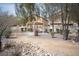Community park featuring shaded picnic tables, and a BBQ grill, surrounded by mature trees and landscaping at 4440 Pacific Crest Ave, Las Vegas, NV 89115