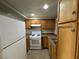 Efficient kitchen showcasing wooden cabinets, white appliances and granite countertops at 4770 Topaz St # 73, Las Vegas, NV 89121