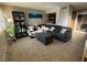 Inviting living room featuring a comfortable gray sectional sofa and a stylish bookcase at 4770 Topaz St # 73, Las Vegas, NV 89121