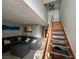 Cozy living room with staircase, featuring a comfortable gray sofa, open to kitchen at 4770 Topaz St # 73, Las Vegas, NV 89121