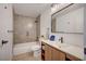 Cozy bathroom featuring a bathtub, modern fixtures, and a vanity sink with wood cabinets at 5071 Pioneer Ave # 203, Las Vegas, NV 89146