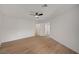 Large bedroom with wood flooring, sliding glass doors, and a ceiling fan at 5071 Pioneer Ave # 203, Las Vegas, NV 89146