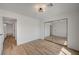 Bright bedroom featuring wood floors, a mirrored closet, and neutral decor at 5071 Pioneer Ave # 203, Las Vegas, NV 89146