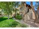 Charming apartment complex featuring stucco exterior, well-maintained landscaping, and mature trees at 5071 Pioneer Ave # 203, Las Vegas, NV 89146