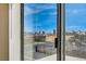 A window view of the city skyline with blue skies and palm trees at 5071 Pioneer Ave # 203, Las Vegas, NV 89146