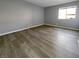 Neutral bedroom featuring wood-look flooring, a window, and light gray walls at 5286 River Glen Dr # 421, Las Vegas, NV 89103