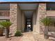 Inviting condo entrance framed by palm trees and stone accents at 5286 River Glen Dr # 421, Las Vegas, NV 89103