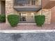 Condo with stone accents, small balcony and manicured landscaping with green bushes and red rock at 5286 River Glen Dr # 421, Las Vegas, NV 89103