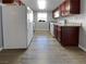 Well-lit kitchen with white appliances, wooden cabinets, and granite countertops at 5286 River Glen Dr # 421, Las Vegas, NV 89103