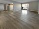 Spacious open floor plan featuring wood floors, kitchen area, and sliding glass doors at 5286 River Glen Dr # 421, Las Vegas, NV 89103