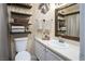 Bathroom with floating shelves, a framed mirror, and neutral tones at 5325 Sandstone Dr, Las Vegas, NV 89142