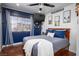 Bedroom with a large window, blue accent wall, and hardwood floors at 5325 Sandstone Dr, Las Vegas, NV 89142
